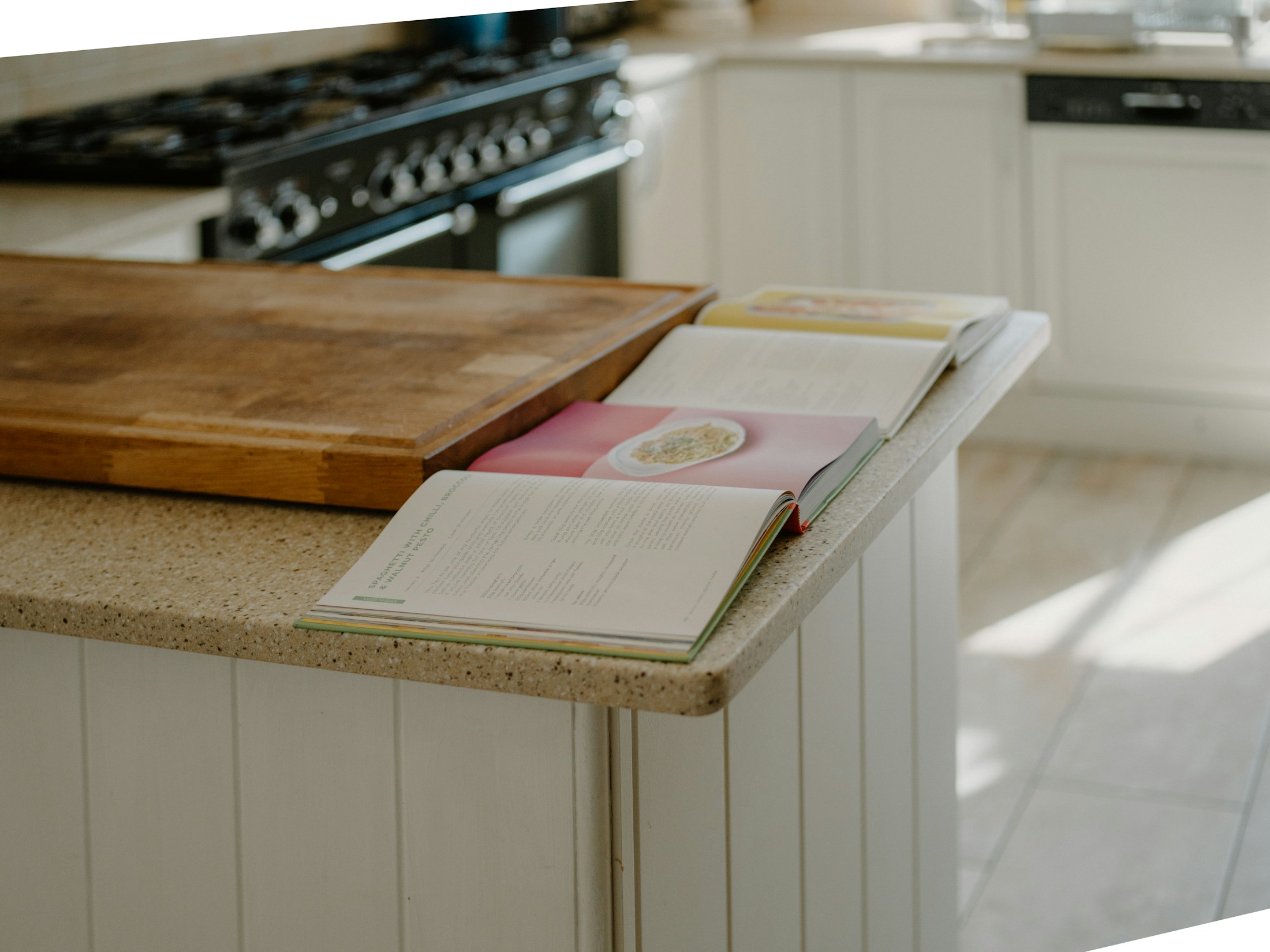 Open cookbooks on a warm home kitchen counter